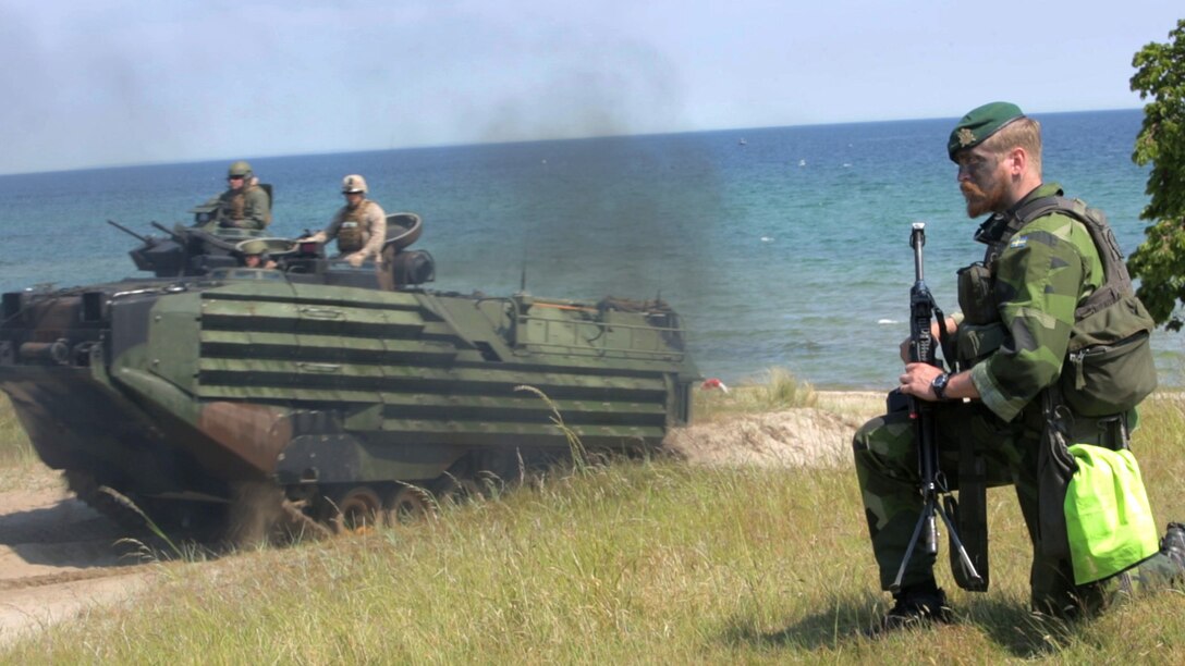 An international Corps of Marines from Sweden, Finland, and the U.K. conduct amphibious assaults on a beachhead in Ravlunda, Sweden, for local media outlets during BALTOPS 2015, June 13. The amphibious forces are part of 17 NATO Allies and partner nations that are integrated in air, land, and sea operations to improve their combined-force capability to work together and to respond to threats in the Baltic region.