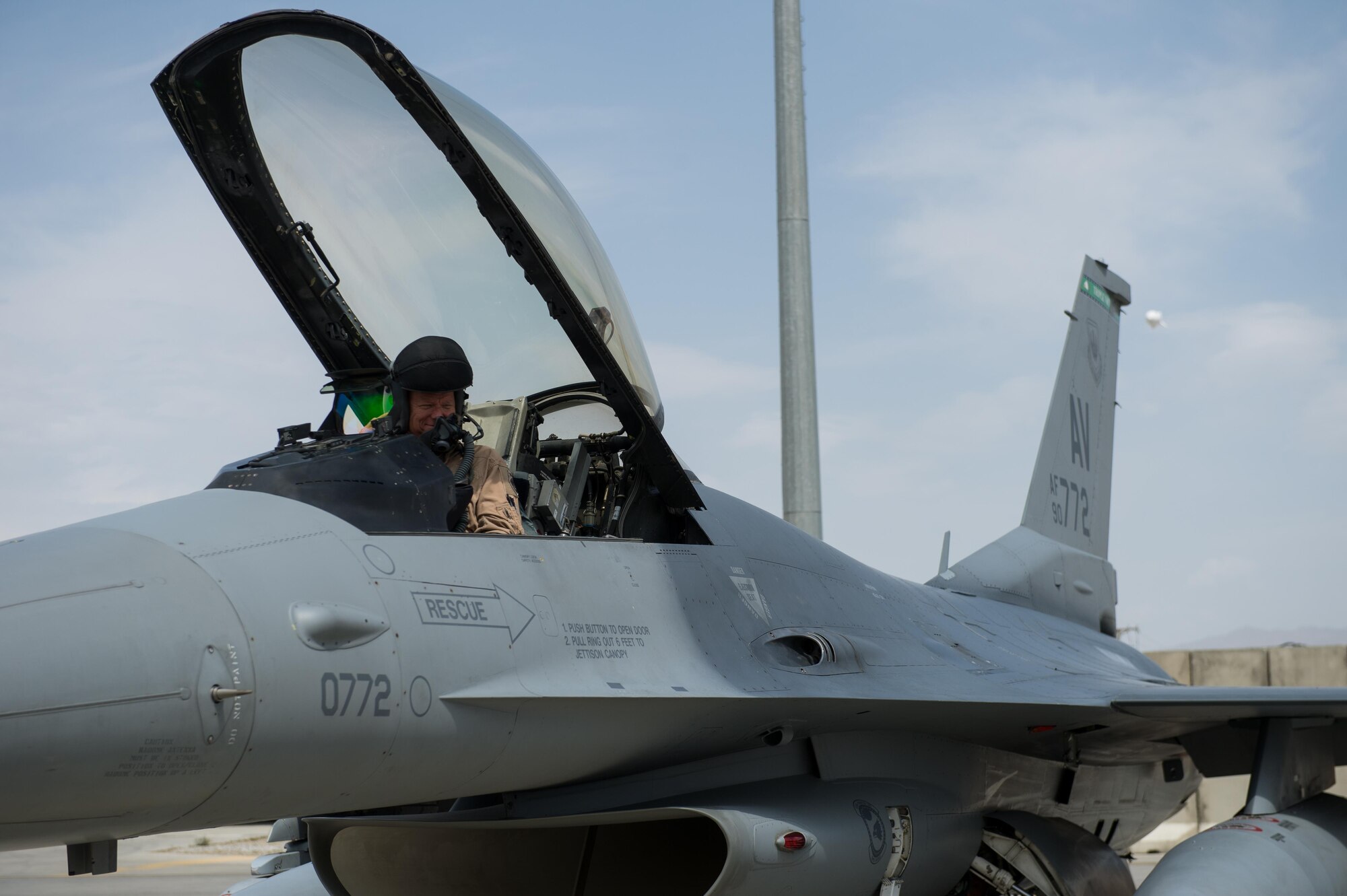 U.S. Air Force Brig. Gen. Mark D. Kelly, 455th Air Expeditionary Wing commander, prepares to exit an F-16 Fighting Falcon aircraft after his final flight as the 455th AEW Commander at Bagram Airfield, Afghanistan, June 28, 2015 The final flight is an aviation tradition in which aircrew members, upon completion of their last flight with the wing, or "fini flight," are met and hosed down with water. (U.S. Air Force photo by Tech. Sgt. Joseph Swafford/Released)