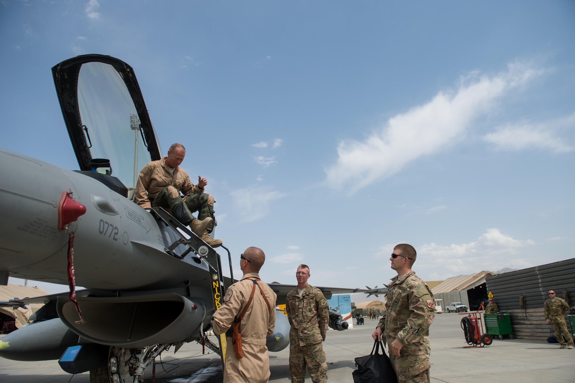 U.S. Air Force Brig. Gen. Mark D. Kelly, 455th Air Expeditionary Wing commander, exits an F-16 Fighting Falcon aircraft after his final flight as the 455th AEW Commander at Bagram Airfield, Afghanistan, June 28, 2015 The final flight is an aviation tradition in which aircrew members, upon completion of their last flight with the wing, or "fini flight," are met and hosed down with water. (U.S. Air Force photo by Tech. Sgt. Joseph Swafford/Released)