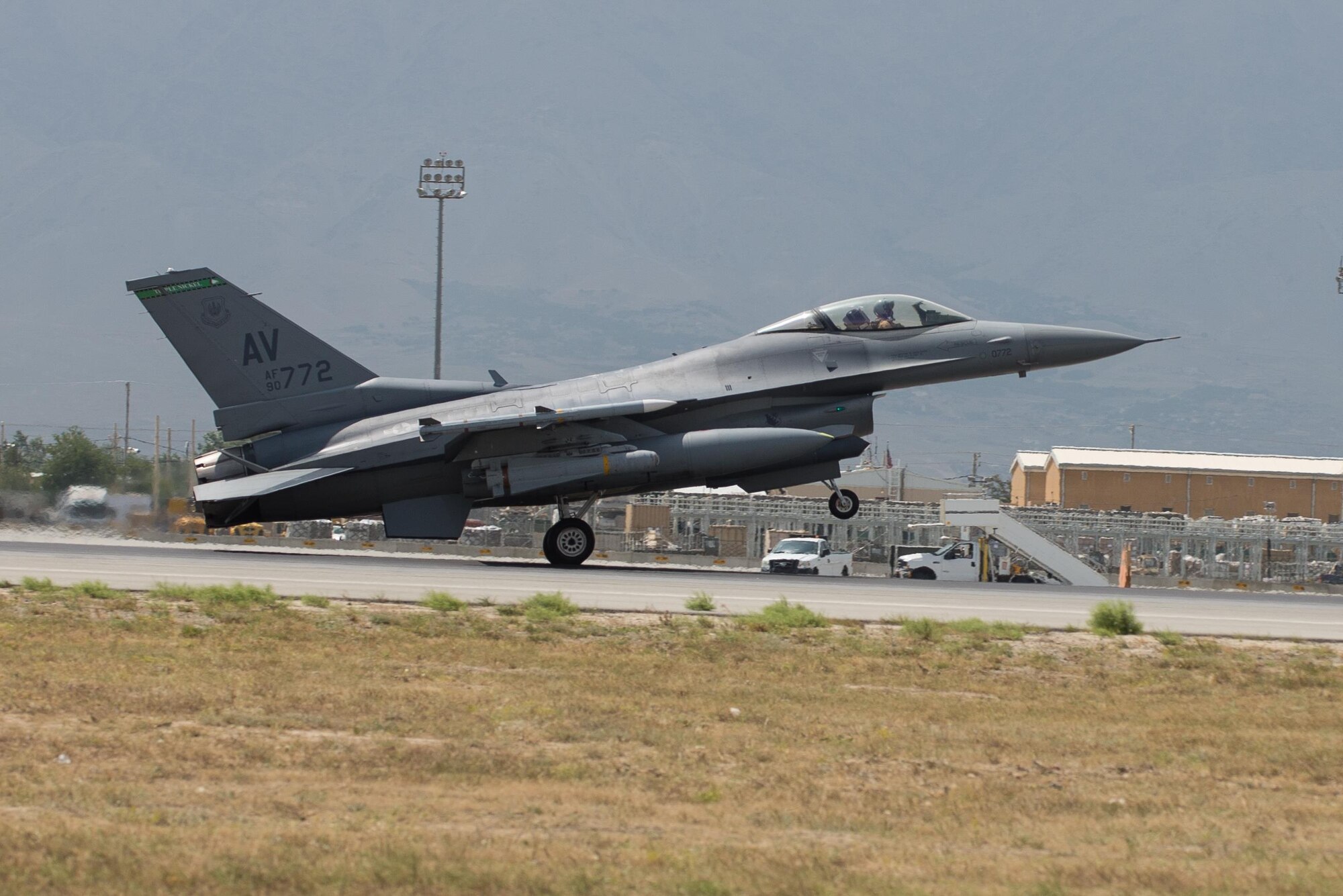 U.S. Air Force Brig. Gen. Mark D. Kelly, 455th Air Expeditionary Wing commander, lands an F-16 Fighting Falcon aircraft during his final flight as the 455th AEW Commander at Bagram Airfield, Afghanistan, June 28, 2015 The final flight is an aviation tradition in which aircrew members, upon completion of their last flight with the wing, or "fini flight," are met and hosed down with water. (U.S. Air Force photo by Tech. Sgt. Joseph Swafford/Released)