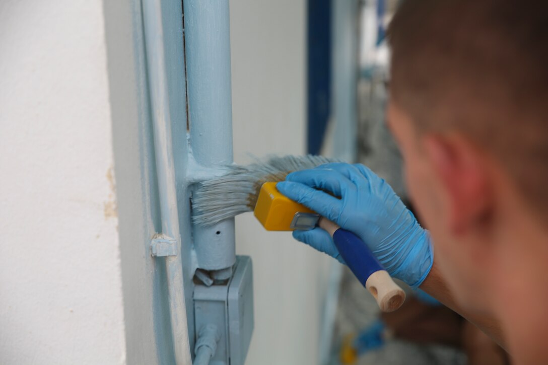 Lance Cpl. Jonah Stevens, a data systems technician assigned to Special-Purpose Marine Air-Ground Task Force Crisis Response-Africa, paints the outside of a conference room at the “Colonia Don Bosco” in Catania, Italy, June 18, 2015. More than 25 Marines and Sailors with SPMAGTF-CR-AF helped refurbish the area in preparation for the summer season, which included painting, raking and constructing a pathway. (U.S. Marine Corps photo by Cpl. Lucas Hopkins/Released)