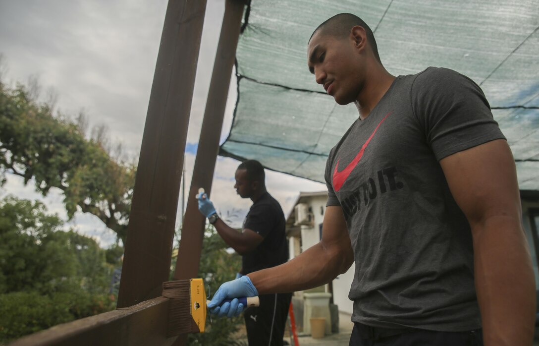 Marine Sgts. Amado Benin II, foreground, and Jeremaine Craighead, paint a patio at the “Colonia Don Bosco” in Catania, Italy, June 18, 2015. Both Marines are assigned to Special-Purpose Marine Air-Ground Task Force Crisis Response-AfricaMore than 25 Marines and Sailors with SPMAGTF-CR-AF joined local residents to paint, rake and construct a pathway at the campsite in preparation for the summer season, which welcomes almost 800 children daily. (U.S. Marine Corps photo by Cpl. Lucas Hopkins/Released)
