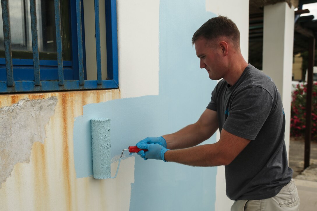 Marine Cpl. William Nash, a radio operator assigned to Special-Purpose Marine Air-Ground Task Force Crisis Response-Africa, paints the outside of a conference room at the “Colonia Don Bosco” in Catania, Italy, June 18, 2015. Nash was one of more than 25 Marines and Sailors with SPMAGTF-CR-AF to help refurbish the campsite alongside local residents. (U.S. Marine Corps photo by Cpl. Lucas Hopkins/Released)