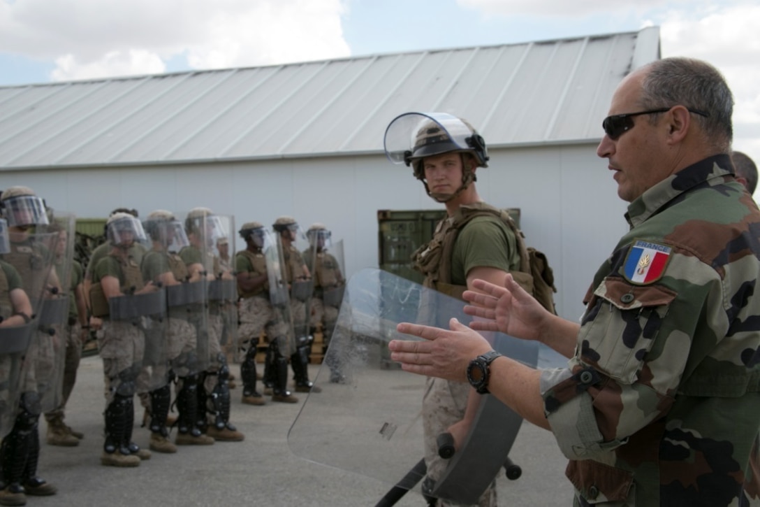 French Lt. Col. Jean-Luc Renault, the course director for a training exercise at the National Gendarmerie Training Center in St. Astier, France, instructs Marines on riot-control techniques at Morón Air Base, Spain, June 15, 2015. The training was an essential precursor for the Marines’ future participation in a bilateral training event with France’s  Escadron de Gendarmerie Mobile  in St. Astier. (U.S. Marine Corps photo by 1st Lt. Danielle Dixon/Released)