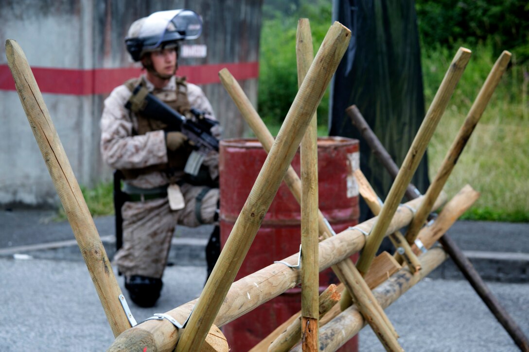 U.S. Marine Lance Cpl. Liam Driscoll, a member of Special-Purpose Marine Air-Ground Task Force Crisis Response-Africa, guards a barricade at the National Gendarmerie Training Center in St. Astier, France, June 19, 2015. The Marines worked side by side with Escadron de Gendarmerie Mobile, a unit with France’s force known as the Gendarmerie, to sustain and enhance their ability to respond to violent and non-violent urban demonstrations. (U.S. Marine Corps photo by 1st Lt. Danielle Dixon/Released)