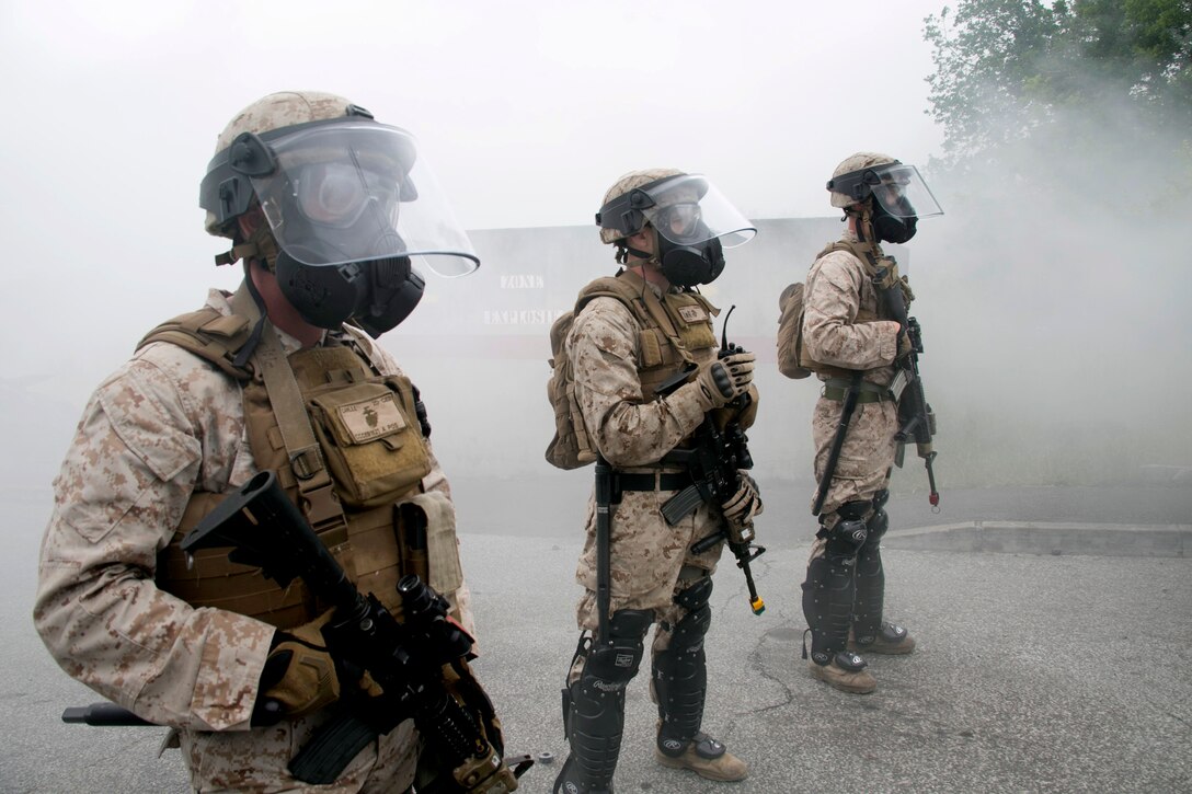 U.S. Marine Cpl. Charles Carlile, left, a member of Special-Purpose Marine Air-Ground Task Force Crisis Response-Africa, holds a defensive line at the National Gendarmerie Training Center in St. Astier, France, June 19, 2015. The Marines trained to respond to a host of urban disturbances and maneuvered their teams without verbal communication.  (U.S. Marine Corps photo by 1st Lt. Danielle Dixon/Released)