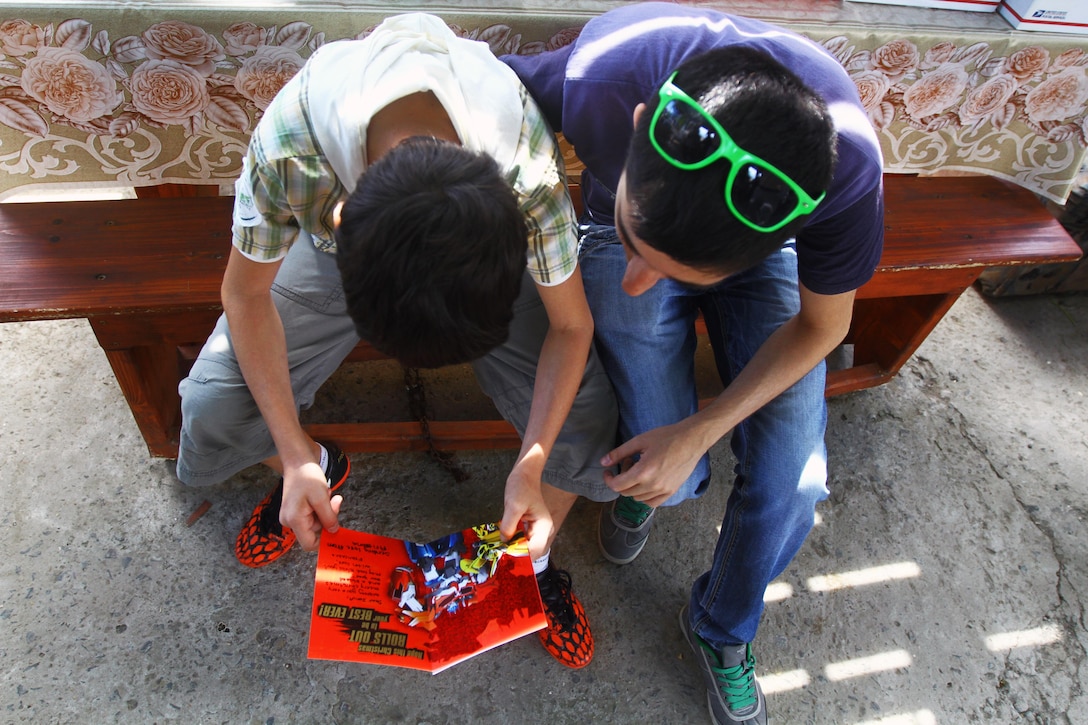 Two Romanian children read a card given by generous Americans provided in a partnership through an organization called United Hands Romania, a nonprofit that works alongside other nonprofits in the United States. The children are part of a group home for neglected children that falls under the Child Protective Agency of Romania. During the event, U.S. Marines with the Black Sea Rotational Force were the stewards who actually presented the gifts to the children.