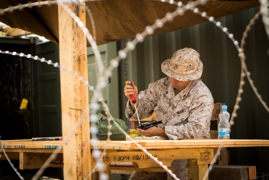 U.S. Marine Corps Cpl. Ramon Licea, a small arms technician with Special-Purpose Marine Air-Ground Task Force Crisis Response-Africa, does maintenance on a Berretta M9 9mm pistol at a Cooperative Security Location in Libreville, Gabon, June 17, 2015. SPMAGTF-CR-AF, currently stationed at Moròn Air Base, Spain, deployed to the CSL to validate the Marine Corps’ ability to forward-stage a force of approximately 200 Marines and sailors. (U.S. Marine Corps photograph by Lance Cpl. Christopher Mendoza/Released)