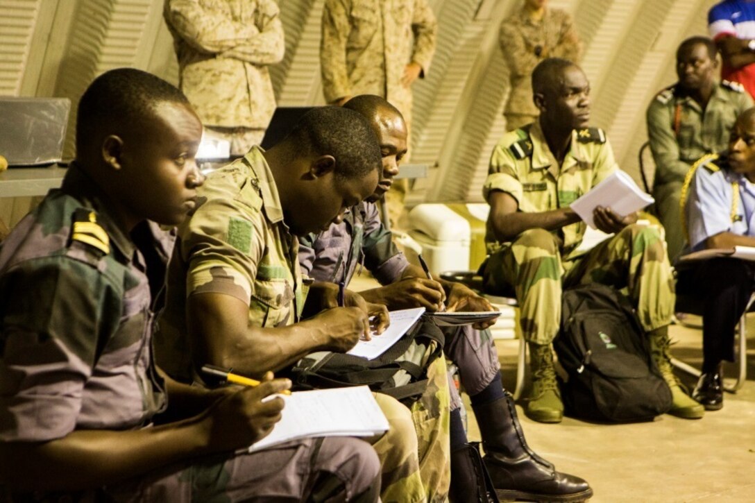 Gabonese service members take notes on a class given by U.S. Marines with Special-Purpose Marine Air-Ground Task Force Crisis Response-Africa at the Marines’ Cooperative Support Location in Libreville, Gabon, June 22, 2015. Marines with SPMAGTF-CR-AF demonstrated the capabilities and functions of different generators to strengthen ties and enhance the knowledge of their partner service members. (U.S. Marine Corps photograph by Lance Cpl. Christopher Mendoza/Released)