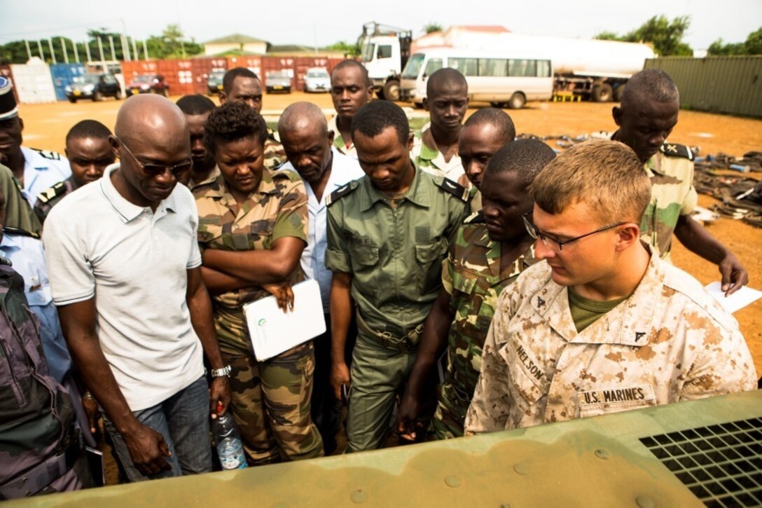 U.S. Marine Corps Lance Cpl. Keegan Nelson, right, a generator mechanic with Special-Purpose Marine Air-Ground Task Force Crisis Response-Africa, explains the different generator components at the Marines’ Cooperative Support Location in Libreville, Gabon, June 22, 2015. Marines with SPMAGTF-CR-AF demonstrated the capabilities and functions of different generators to strengthen ties and enhance the knowledge of their partner service members. (U.S. Marine Corps photograph by Lance Cpl. Christopher Mendoza/Released)