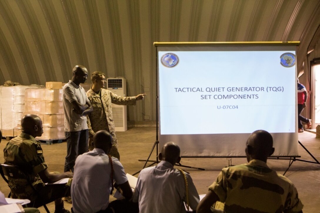 U.S. Marine Corps Lance Cpl. Keegan Nelson, left, a generator mechanic with Special-Purpose Marine Air-Ground Task Force Crisis Response-Africa, gives a class on the basic components of various generators to Gabonese service members at the Marines’ Cooperative Support Location in Libreville, Gabon, June 22, 2015. Marines with SPMAGTF-CR-AF demonstrated the capabilities and functions of different generators to strengthen ties and enhance the knowledge of their partner service members. (U.S. Marine Corps photograph by Lance Cpl. Christopher Mendoza/Released)