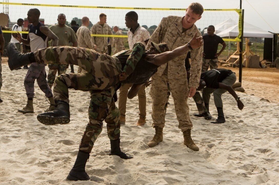 Gabonese Gendarmerie service members demonstrate different non-lethal takedown techniques at a Cooperative Security Location established by Marines with Special-Purpose Marine Air-Ground Task Force Crisis Response-Africa in Libreville, Gabon, June 24, 2015. The Marines partnered with the Gabonese Gendarmerie unit to hone their riot and crowd control tactics and procedures. The Marines, who are based out of Morón Air Base, Spain, are currently validating their forward-staging capabilities aboard the CSL while building partnerships with their Gabonese counterparts. (U.S. Marine Corps photograph by Lance Cpl. Christopher Mendoza/Released)
