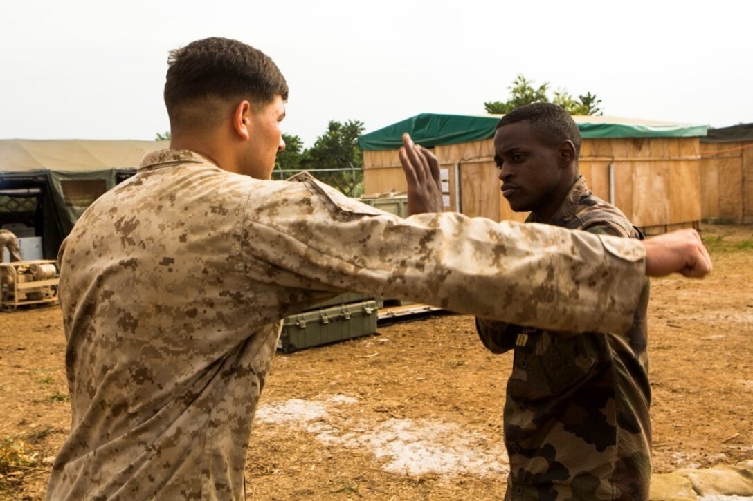 U.S. Marine Corps Lance Cpl. Logan English, left, a rifleman with Special-Purpose Marine Air-Ground Task Force Crisis Response-Africa, practices non-lethal techniques with a Gabonese Gendarmerie service member at the Marines’ Cooperative Security Location in Libreville, Gabon, June 24, 2015. The Marines partnered with the Gabonese Gendarmerie unit to hone their riot and crowd control tactics and procedures. The Marines, who are based out of Morón Air Base, Spain, are currently validating their forward-staging capabilities aboard the CSL while building partnerships with their Gabonese counterparts. (U.S. Marine Corps photograph by Lance Cpl. Christopher Mendoza/Released)