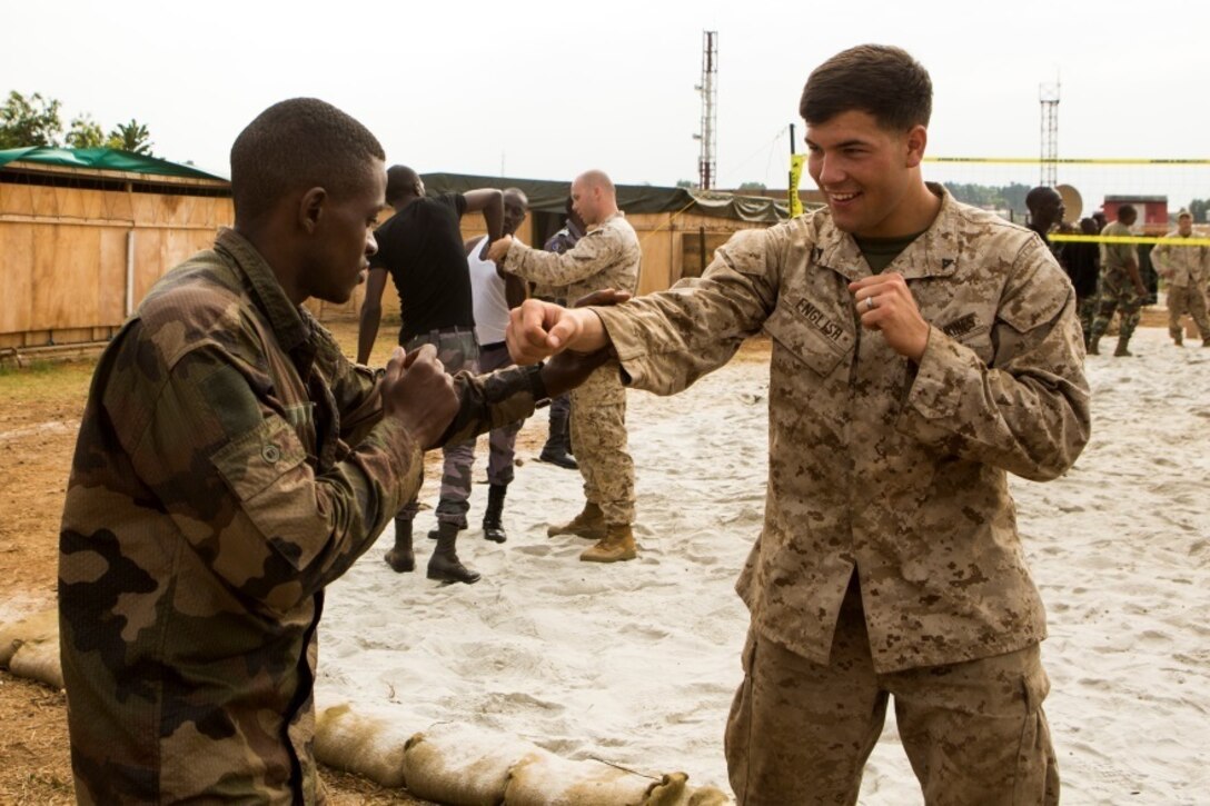 U.S. Marine Corps Lance Cpl. Logan English, right, a rifleman with Special-Purpose Marine Air-Ground Task Force Crisis Response-Africa, practices non-lethal techniques with a Gabonese Gendarmerie service member at the Marines’ Cooperative Security Location in Libreville, Gabon, June 24, 2015. The Marines partnered with the Gabonese Gendarmerie unit to hone their riot and crowd control tactics and procedures. The Marines, who are based out of Morón Air Base, Spain, are currently validating their forward-staging capabilities aboard the CSL while building partnerships with their Gabonese counterparts. (U.S. Marine Corps photograph by Lance Cpl. Christopher Mendoza/Released)