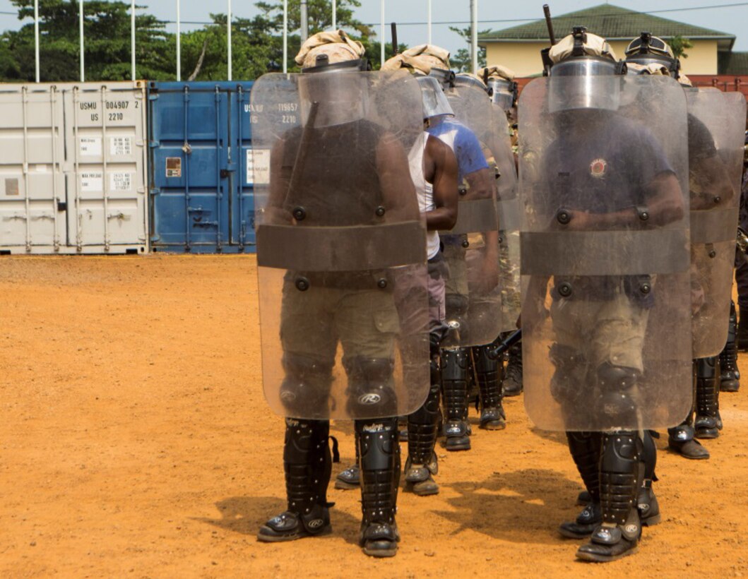 Gabonese Gendarmerie service members demonstrate their riot and crowd control techniques at a Cooperative Security Location established by U.S. Marines with Special-Purpose Marine Air-Ground Task Force Crisis Response-Africa in Libreville, Gabon, June 24, 2015. The Gabonese Gendarmerie unit is tasked with containing riots and even responding to situations that may occur outside the nearby embassy. The service members with SPMAGTF-CR-AF, which is based out of Moròn Air Base, Spain, are currently validating their forward-staging capabilities while building partnerships with their Gabonese counterparts. (U.S. Marine Corps photograph by Lance Cpl. Christopher Mendoza/Released)