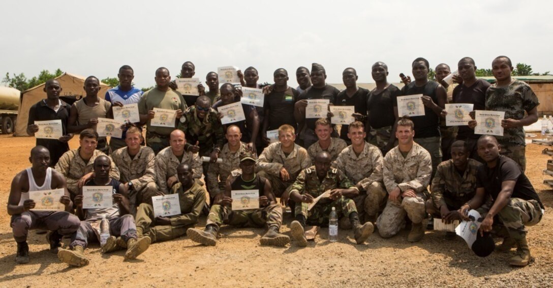 U.S. Marines and Sailors with Special-Purpose Marine Air-Ground Task Force Crisis Response-Africa pose for a picture with Gabonese Gendarmerie service members after a graduation ceremony for participates in a non-lethal weapons training course at SPMAGTF-CR-AF’s Cooperative Security Location in Libreville, Gabon, June 24, 2015. The Gabonese Gendarmerie unit is tasked with containing riots and even responding to situations that may occur outside the nearby embassy. The service members with SPMAGTF-CR-AF, which is based out of Morón Air Base, Spain, are currently validating their forward-staging capabilities while building partnerships with their Gabonese counterparts. (U.S. Marine Corps photograph by Lance Cpl. Christopher Mendoza/Released)