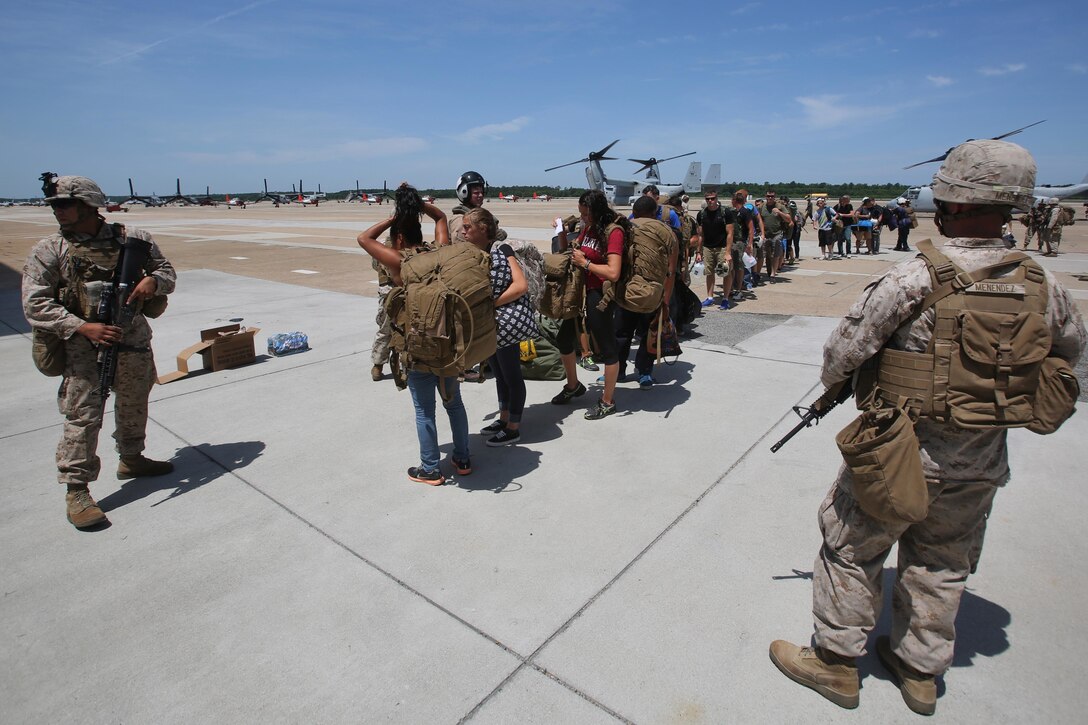 Marines with Kilo Co., 3rd Battalion, 8th Marine Regiment, provide security for American citizens at the evacuation command center during a simulated embassy evacuation aboard Naval Air Station Oceana, Va. The ECC is part of a week-long Special Purpose Marine Air Ground Task Force - Crisis Response- Africa certification exercise, the final step in pre-deployment training. (U.S. Marine Corps photo by Staff Sgt. Vitaliy Rusavskiy/ Released)