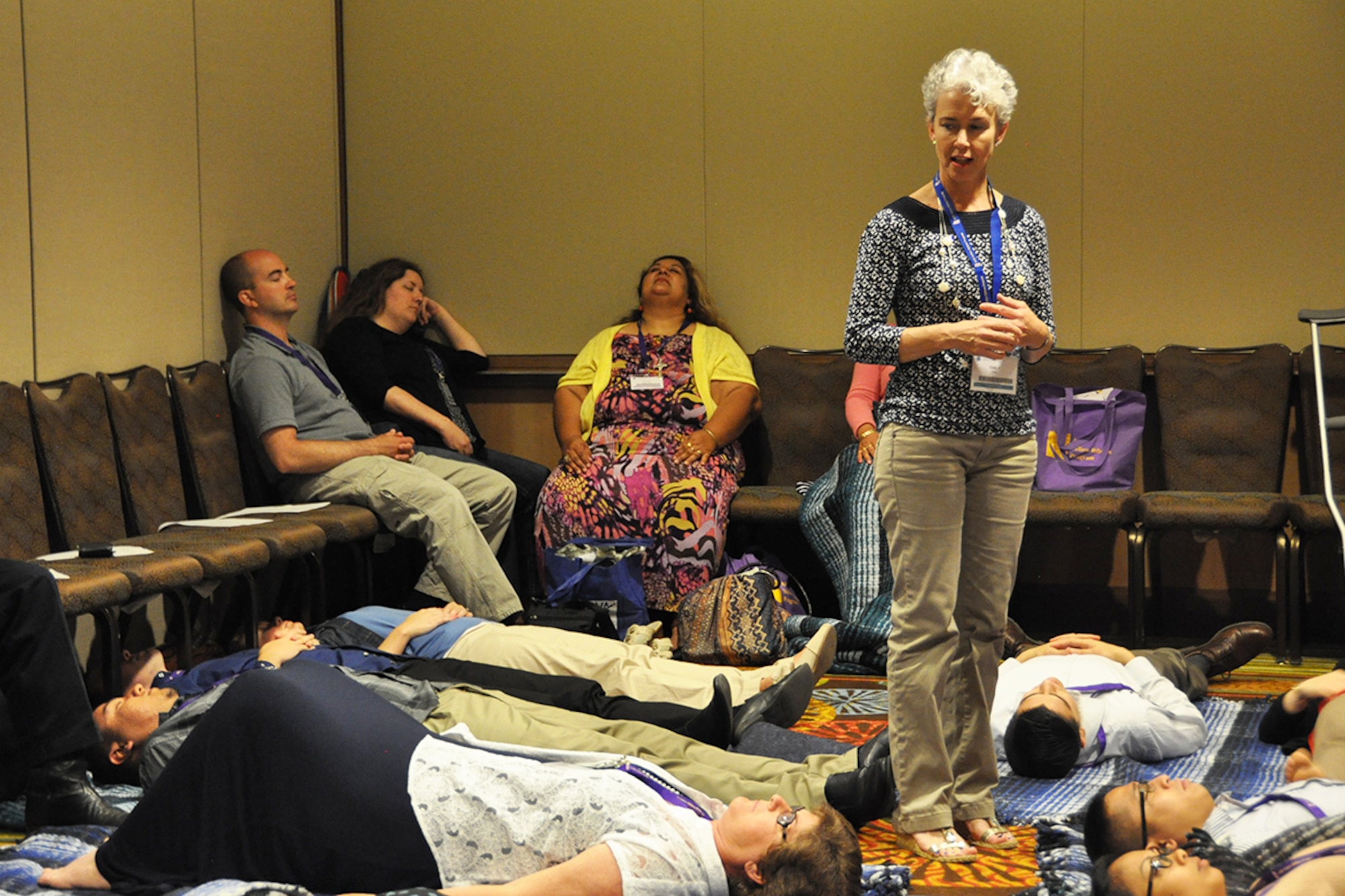 Emily Hain, Integrative Restoration and yoga instructor, monitors Air Force Reserve members and their families June 27, 2015, during a breakout session at an Air Force Reserve Yellow Ribbon Program training event in Orlando, Florida. Yellow Ribbon promotes the well-being of reservists and their families by connecting them with resources before and after deployments. (U.S Air Force photo/Master Sgt. James Branch)