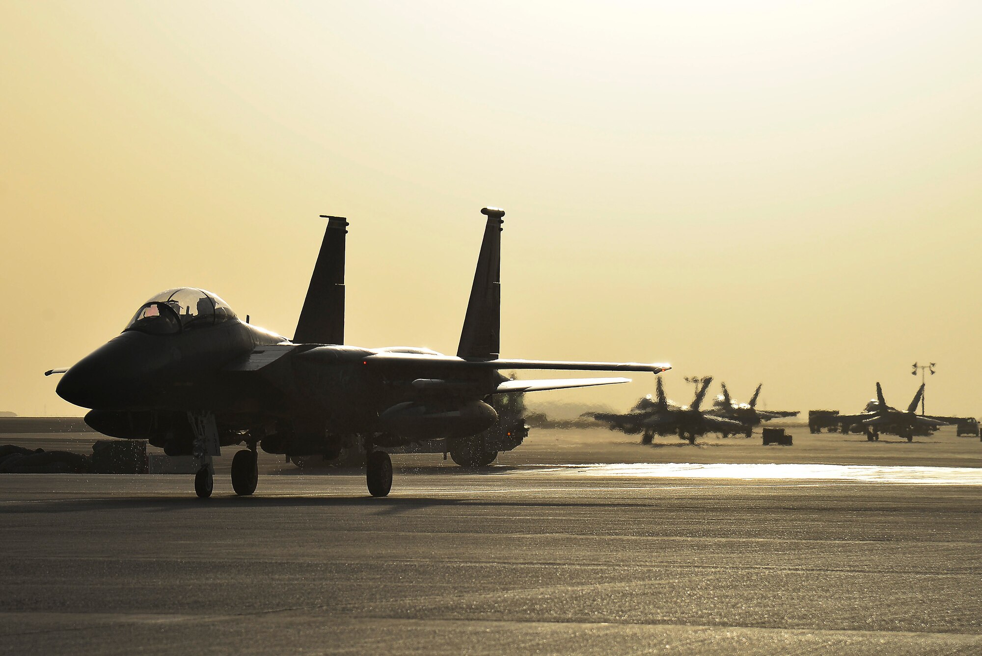Brig. General John T. Quintas taxis on the flightline after completing his fini flight at an undisclosed location in Southwest Asia June 25, 2015. Quintas is a master navigator and the commander of the Air Expeditionary Wing. (U.S. Air Force photo/Tech. Sgt. Christopher Boitz)