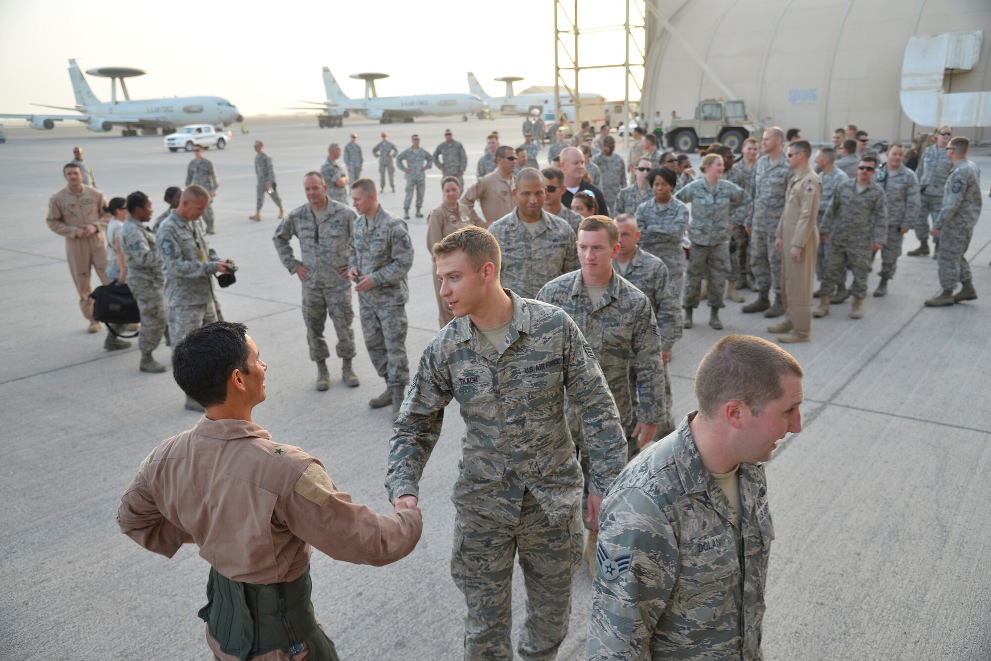 Airmen from the Air Expeditionary Wing congratulate Brig. General John T. Quintas after completing his fini flight at an undisclosed location in Southwest Asia June 25, 2015. Quintas is a master navigator and the commander of the Air Expeditionary Wing. (U.S. Air Force photo/Tech. Sgt. Christopher Boitz)