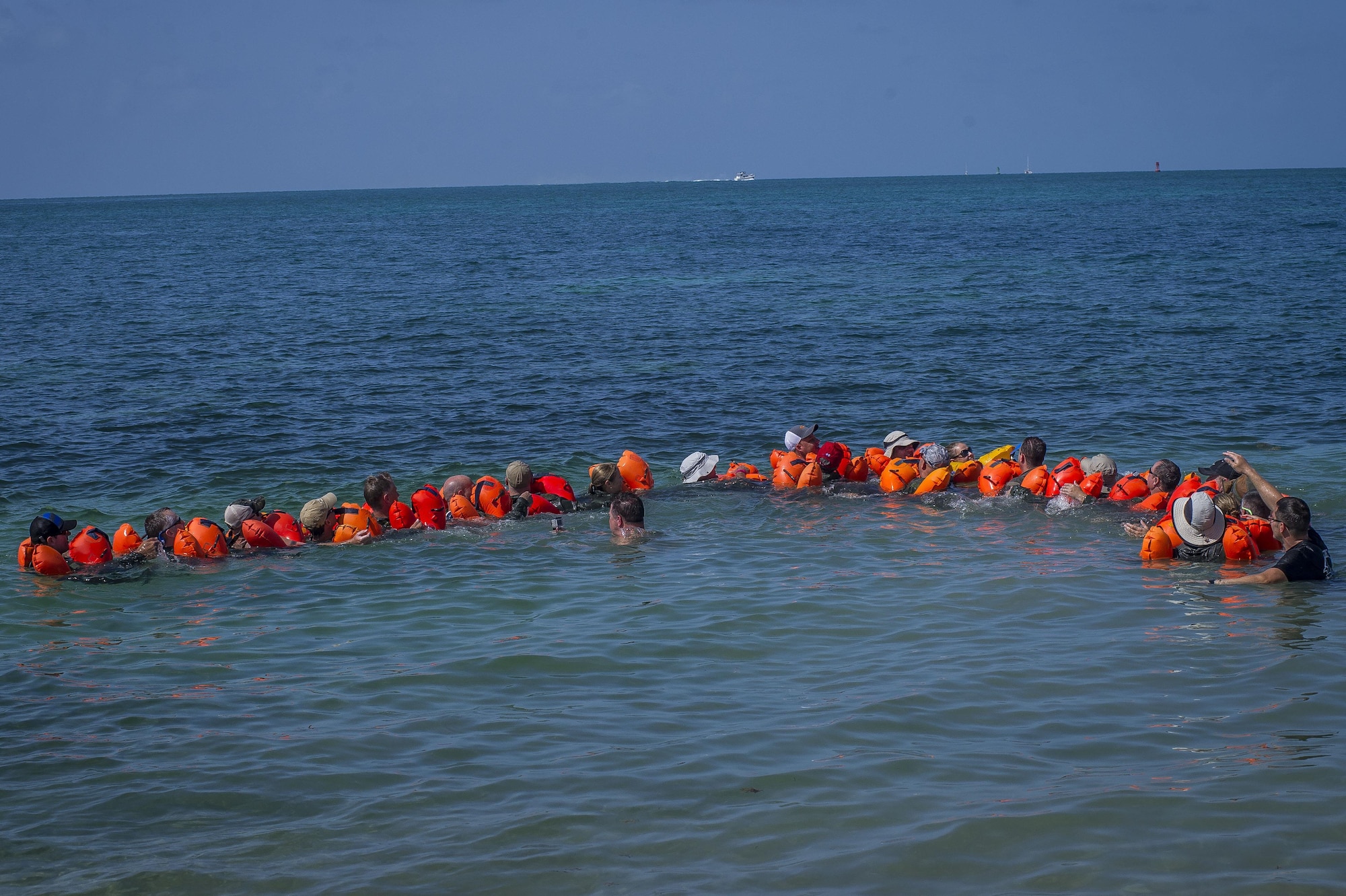 Airmen prepare to conduct a body drag during a water survival exercise June 27, 2015, at Naval Air Station Key West, Fla. More than 90 Airmen from the 300th Airlift Squadron deployed for a mass exercise that involved accomplished more than 500 training tasks. (U.S. Air Force photo by Senior Airman Tom Brading)