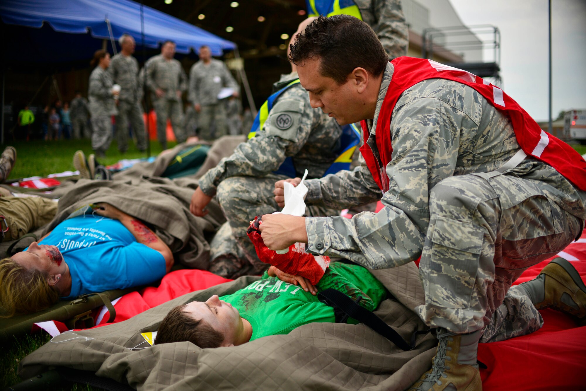 Emergency Response personnel treat victims of a simulated C-130 Aircraft hard landing as part of the Major Accident Response Exercise, June 27, 2015, Niagara Falls Air Reserve Station, N.Y. The MARE is an important part of keeping Niagara’s team ready to respond in an emergency situation. (U.S. Air Force photo by Tech. Sgt. Stephanie Sawyer) 
