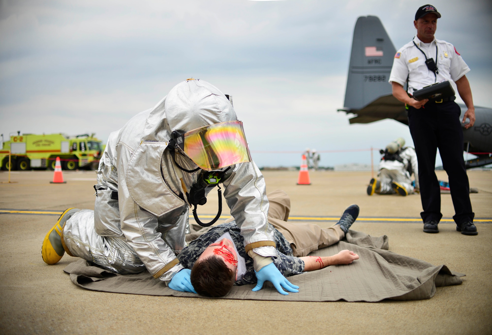 A member of the Emergency Response team assesses a victim of a simulated C-130 Aircraft hard landing as part of the Major Accident Response Exercise, June 27, 2015, Niagara Falls Air Reserve Station, N.Y. The MARE is an important part of keeping Niagara’s team ready to respond in an emergency situation. (U.S. Air Force photo by Tech. Sgt. Stephanie Sawyer) 
