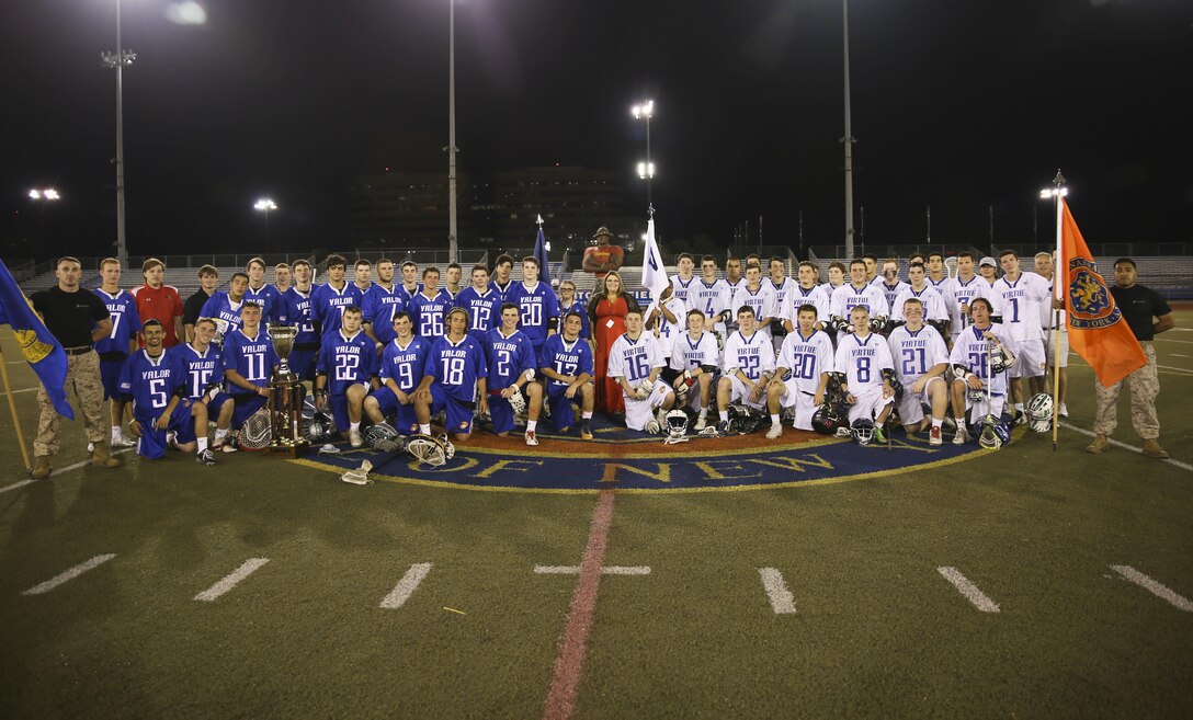 Team Valor and Virtue pose for a photo after the 2nd Annual Dan Daly Cup in Uniondale, N.Y, June 24. Team Valor and Team Virtue are comprised of the top high school junior lacrosse players across Long Island competing to win the trophy named in honor of two-time Medal of Honor recipient Sgt. Maj. Daniel Daly. The win later went to Team Valor with the final score of 11-10. (U.S. Marine Corps photo by Cpl. Elizabeth Thurston)