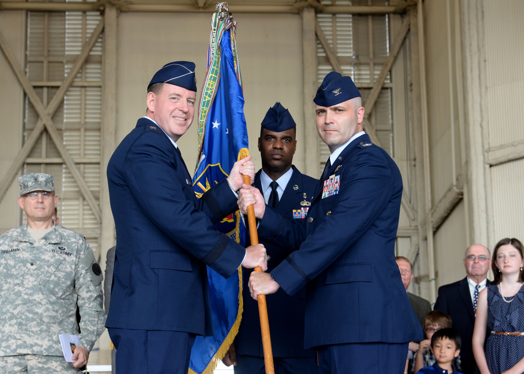 U.S. Air Force Maj. Gen. James Hecker, 19th Air Force commander, presents the 97th Air Mobility Wing guidon to U.S. Air Force Col. Todd Hohn, 97th AMW commander, during the 97th AMW Change of Command Ceremony at Altus Air Force Base, Oklahoma, June 26, 2015. Hohn assumed command as the new wing commander where he will lead the Airmen of the base in supporting the mission of forging combat mobility forces and deploying Airmen warriors. (U.S. Air Force photo by Senior Airman Franklin R. Ramos)