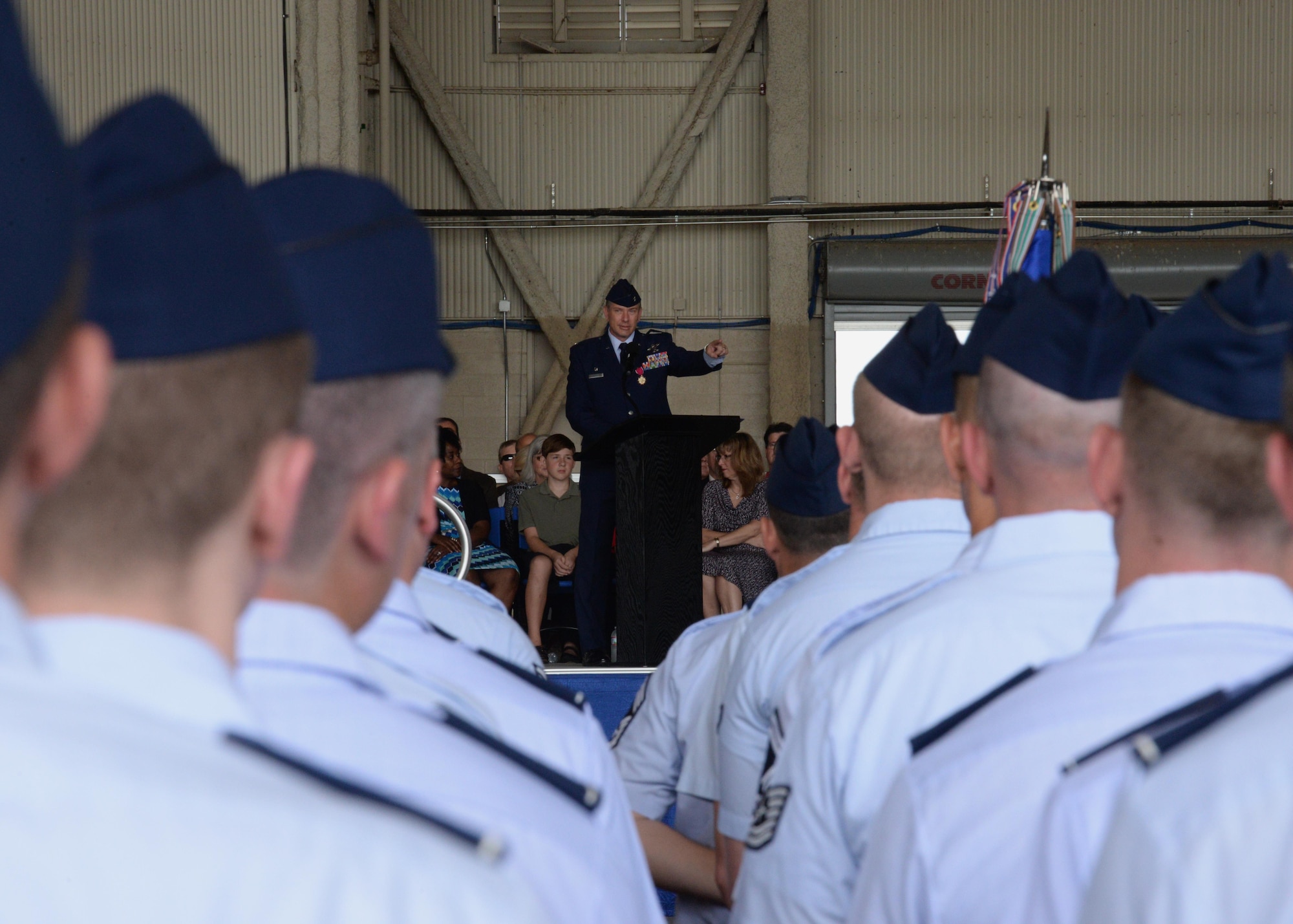 U.S. Air Force Col. Bill Spangenthal, outgoing 97th Air Mobility Wing commander, addresses the Airmen of Altus Air Force Base, Oklahoma, during the 97th AMW Change of Command Ceremony here June 26, 2015. Spangenthal transferred command of the 97th AMW to U.S. Air Force Col. Todd Hohn after serving in the role since June 2013. (U.S. Air Force photo by Airman 1st Class Megan E. Acs)