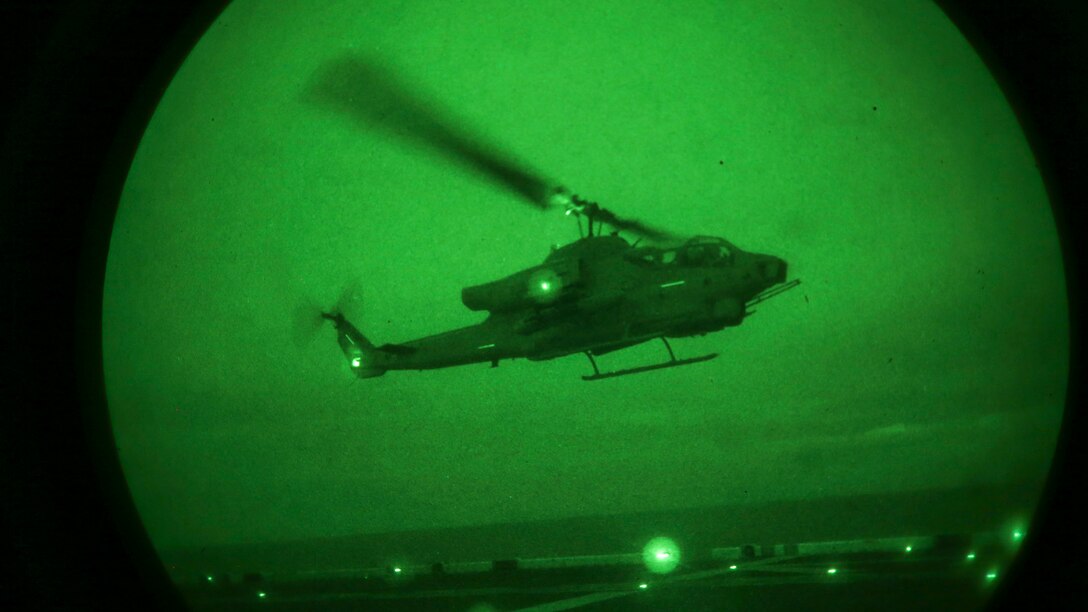A U.S. Marine Corps AH-1 Super Cobra with Marine Medium Tiltrotor Squadron (VMM) 162 (REINFORCED), 26th Marine Expeditionary Unit, flies off the flight-line during an Amphibious Ready Group/Marine Expeditionary Unit Exercise (ARG/MEU-Ex) aboard the USS Kearsarge, June 25, 2015. The 26th MEU and Amphibious Squadron 4 are conducting an ARG/MEU-Ex in preparation for their deployment to the 5th and 6th Fleet areas of responsibility later this year. (U.S. Marine Corps photo by Cpl. Joshua W. Brown/Released)