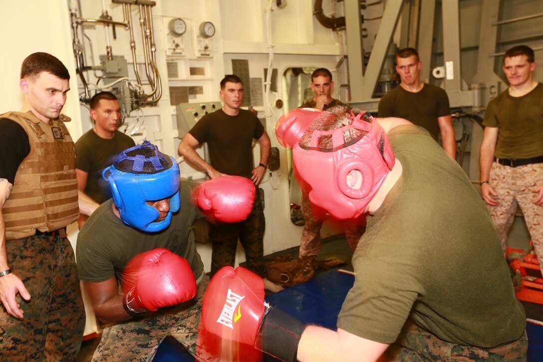 ARABIAN SEA (June 24, 2015) U.S. Marines spar during a Martial Arts Instructor Course aboard the USS Anchorage (LPD 23). The students are going through the rigorous course in order to become MCMAP instructors for their respective units. Anchorage is part of the Essex Amphibious Ready Group, and, with the embarked 15th Marine Expeditionary Unit, is deployed in support of maritime security operations and theater security cooperation efforts in the U.S. 5th Fleet area of operations. (U.S. Marine Corps photo by Sgt. Jamean Berry/Released)