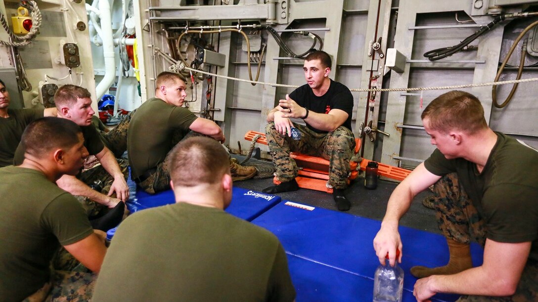 ARABIAN SEA (June 23, 2015) U.S. Marine Cpl. Ryan Jackson leads his students in a guided discussion during a Martial Arts Instructor Course.  Jackson is a rifleman and a martial arts instructor trainer with Battalion Landing Team 3rd Battalion, 1st Marine Regiment, 15th Marine Expeditionary Unit.   USS Anchorage (LPD 23): Anchorage is part of the Essex Amphibious Ready Group and, with the embarked 15th MEU, is deployed in support of maritime security operations and theater security cooperation efforts in the U.S. 5th Fleet area of operations. (U.S. Marine Corps photo by Sgt. Jamean Berry/Released)
