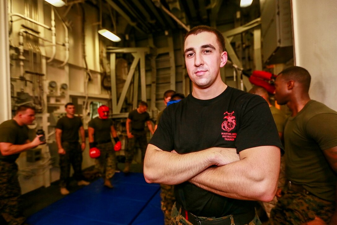 ARABIAN SEA (June 23, 2015) U.S. Marine Cpl. Ryan Jackson instructs Marines on how to teach a Marine Corps Martial Arts Course. Jackson is a rifleman and a martial arts instructor trainer with Battalion Landing Team 3rd Battalion, 1st Marine Regiment, 15th Marine Expeditionary Unit.  Jackson goes above and beyond his normal duties as a rifleman to take on the challenge of being an instructor trainer for MCMAP. "This helps them build as a team to work better with their peers, subordnants and their leaders." said Jackson.  USS Anchorage (LPD 23): Anchorage is part of the Essex Amphibious Ready Group and, with the embarked 15th MEU, is deployed in support of maritime security operations and theater security cooperation efforts in the U.S. 5th Fleet area of operations. (U.S. Marine Corps photo by Sgt. Jamean Berry/Released)