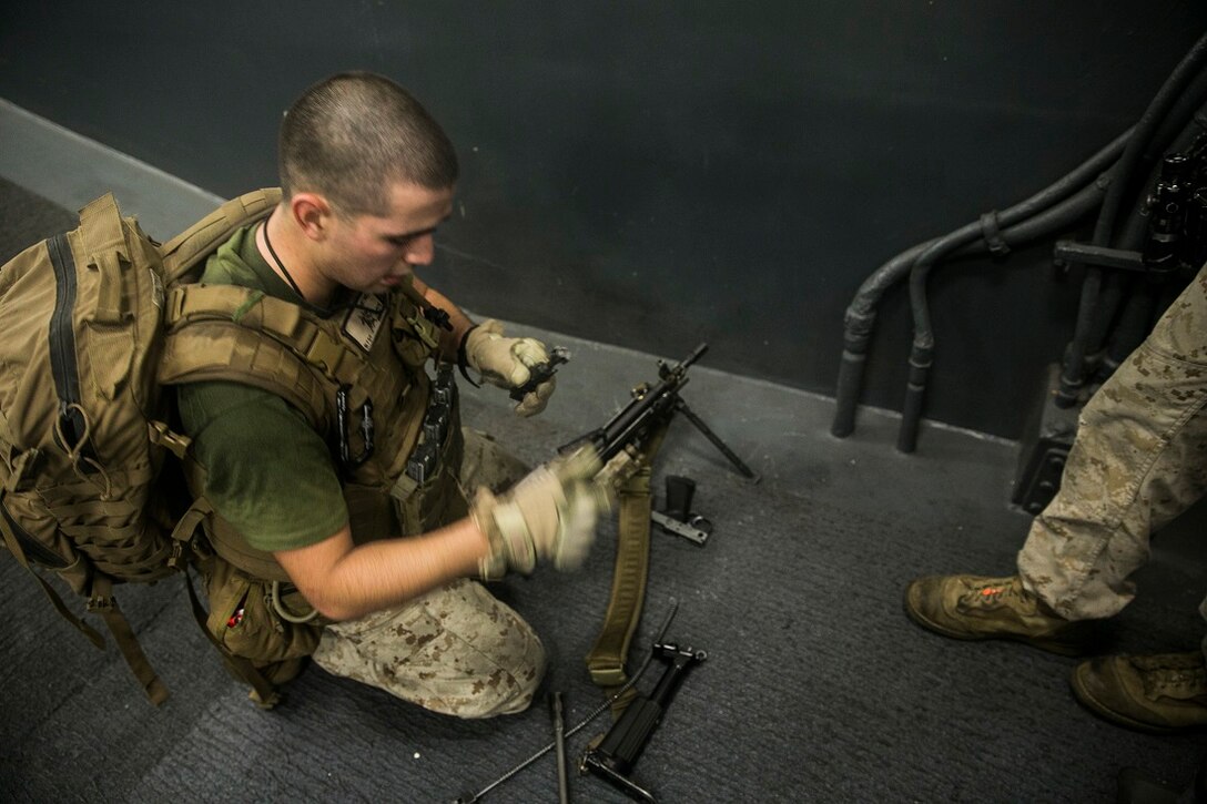ARABIAN SEA (June 24, 2015) U.S. Marine Lance Cpl. Manuel Martinez assembles his M240B machine gun during combat conditioning aboard the USS Essex (LHD 2). Martinez is a member of Lima Company, Battalion Landing Team 3rd Battalion, 1st Marine Regiment, 15th Marine Expeditionary Unit. The combat conditioning incorporated tactical drills as well as physical drills to further stress the Marines and prepare them for the rigors of deployment. The 15th MEU is embarked on the Essex Amphibious Ready Group and deployed to maintain regional security in the U.S. 5th Fleet area of operations. (U.S. Marine Corps photo by Cpl. Anna Albrecht/ Released)
