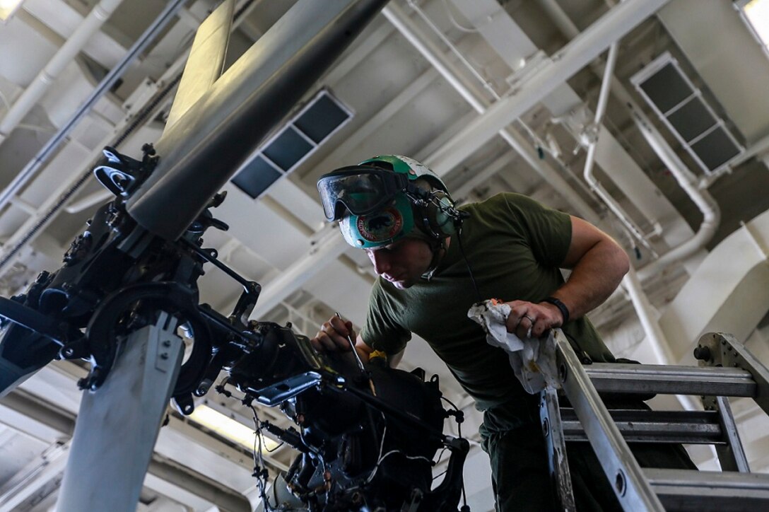 ARABIAN SEA (June 24, 2015)  U.S. Marine Cpl. Dylan Kelley applies an anti-corrosion solution to helicopter rotor components aboard the USS Anchorage (LPD 23). This type of maintenance keeps the aircraft running in top condition during the deployment. Anchorage is part of the Essex Amphibious Ready Group, and, with the embarked 15th Marine Expeditionary Unit, is deployed in support of maritime security operations and theater security cooperation efforts in the U.S. 5th Fleet area of operations. (U.S. Marine Corps photo by Sgt. Jamean Berry/Released)