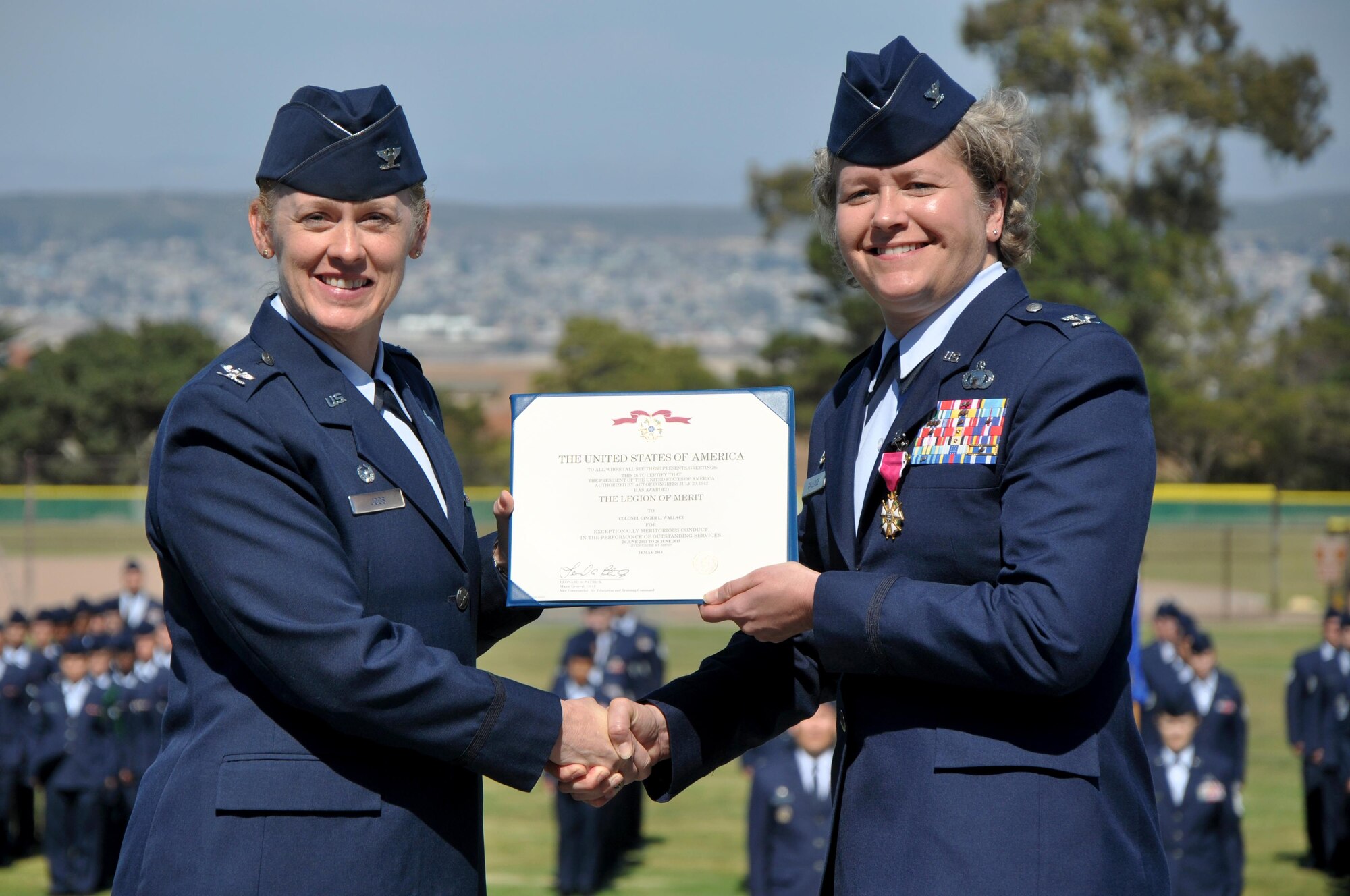 U.S. Air Force Col. Kimberlee P. Joos, 17th Training Wing Commander, awards Col. Ginger L. Wallace, 517th Training Group Commander, the Legion of Merit during the 517th TRG change of command ceremony at the Presidio of Monterey, California, June 26, 2015. Wallace served as commander of the 517th TRG for two years before relinquishing command to Col. Keith M. Logeman. (U.S. Air Force photo by Senior Airman Joshua Edwards/ released)