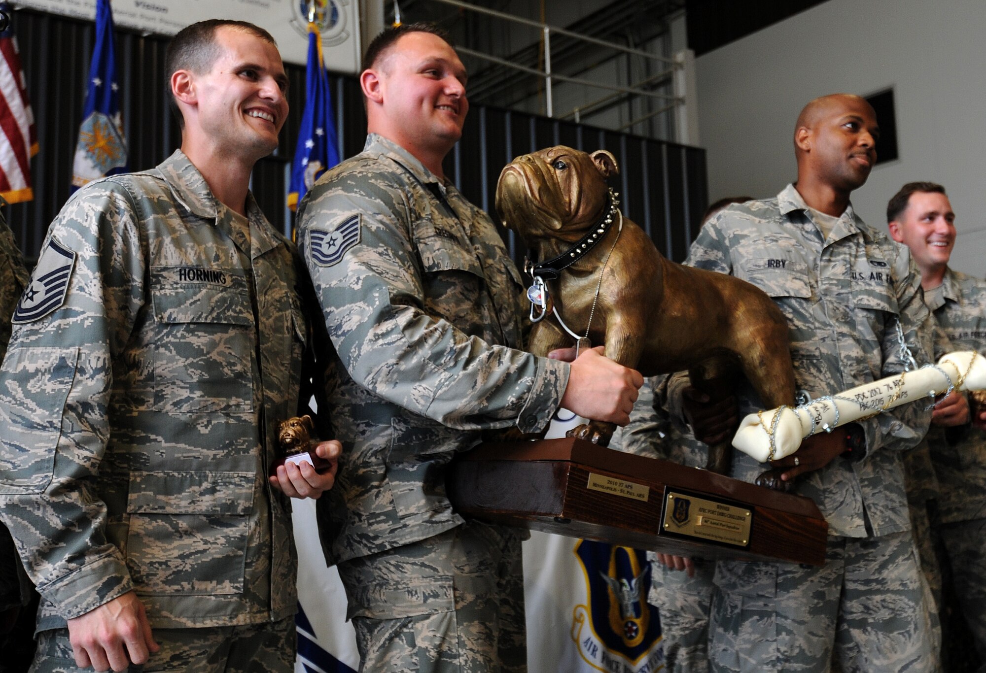 U.S. Air Force members from the 76th Aerial Port Squadron pose for photographs for winning the "Top Dawg" award as best overall aerial port squadron at the closing ceremonies during the Port Dawg Challenge at Dobbins Air Reserve Base, Ga., June 18, 2015. The Port Dawg Challenge was created to enhance and maintain the camaraderie, espirt de corp and prestige of Aerial Port Airmen while promoting professionalism, leadership, training and communication between "Port Dawgs." (U.S. Air Force photo by Tech. Sgt. Stephen D. Schester/Released)