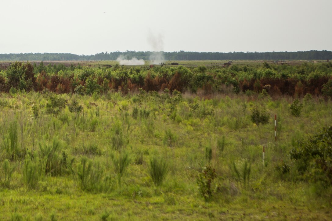 Marines with 2nd Battalion, 2nd Marine Regiment observe a mortar impact during a live-fire exercise aboard Camp Lejeune, N.C., June 25, 2015.  The live-fire range was conducted to better train the Marines with the direct lay method of fire, which requires the Marines to corrections while firing.  (U.S. Marine Corps photo by Cpl. Michael Dye/Released)