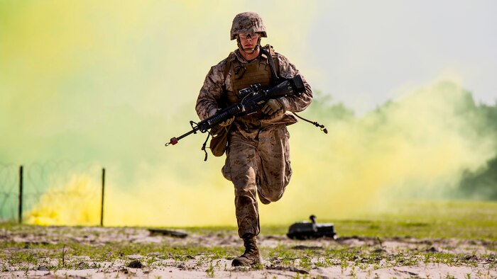 Lance Cpl. Alex Rowan, a combat engineer with 4th Combat Engineer Battalion, 4th Marine Division, stationed out of Bessemer, Alabama, runs to take cover before the Anti-Personnel Obstacle Breaching System detonates during the SAPPER Leaders Course at Marine Corps Base Camp Lejeune, North Carolina, June 26, 2015. During the course, the Marines used assault and breaching techniques to clear a wire obstacle using line charges that utilized C4 explosives and their APOBS. 