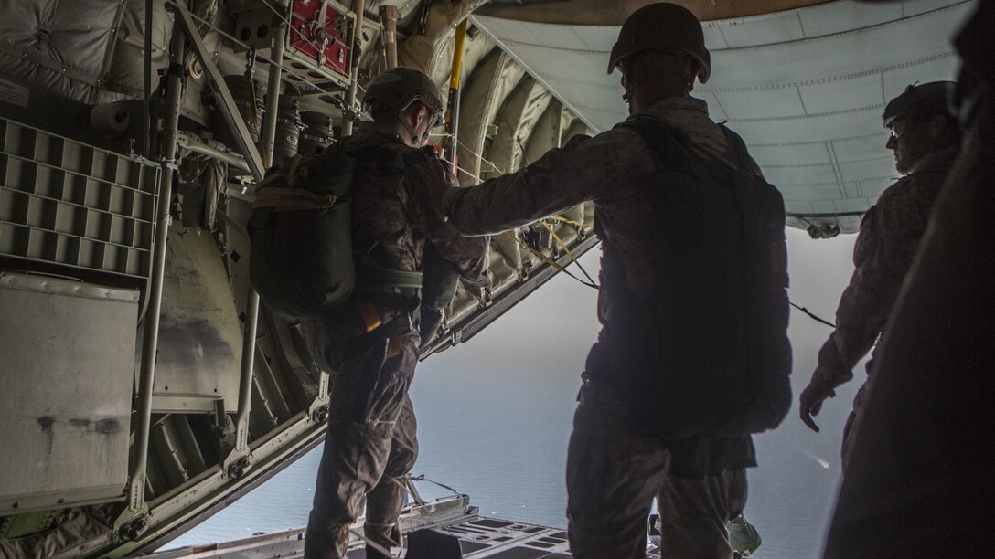 Marines with 2nd Reconnaissance Battalion, 2nd Marine Division, leap from a C130J and into the Atlantic Ocean during intentional water jump training at Marine Corps Base Camp Lejeune, North Carolina June 24, 2015. The training evaluated the Marines’ ability to properly insert via  parachute into an aquatic environment.