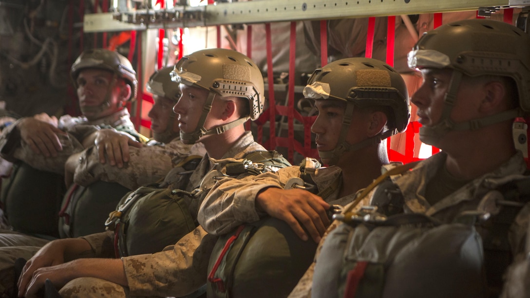 Marines with 2nd Reconnaissance Battalion, 2nd Marine Division, perform last minute checks to their equipment aboard a C130J during intentional water training at Marine Corps Base Camp Lejeune, North Carolina June 24, 2015. The training prepared the Marines for situations that require them to dive in an aquatic environment.