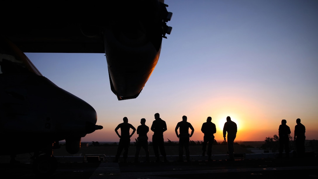 Marines with the 24th Marine Expeditionary Unit, watch the sunset as the amphibious assault ship USS Iwo Jima sails through the Suez Canal, June 21, 2015. The 24th MEU and Iwo Jima Amphibious Ready Group transited through the canal, a 120-mile long waterway connecting the Red Sea to the Mediterranean, and entered the U.S. 6th Fleet area of operations. The 24th MEU is deployed on the ships of the Iwo Jima ARG in support of U.S. national security interests in the U.S. 6th Fleet area of operations.
