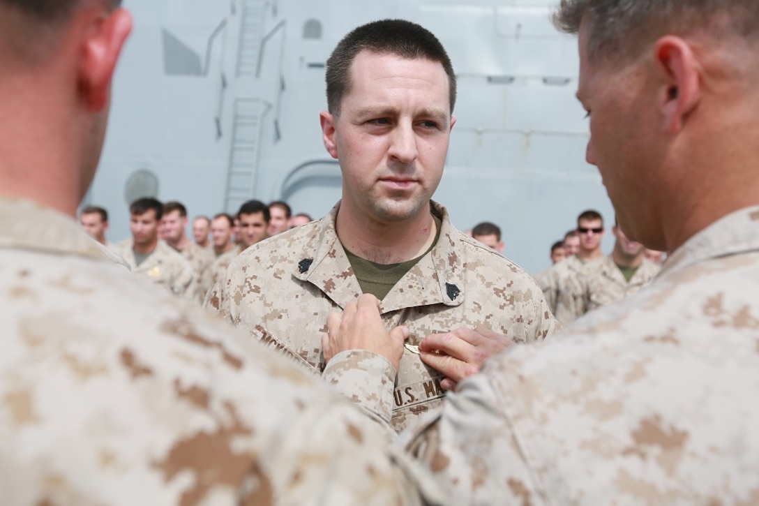U.S. Marine Capt. John Garlasco, left, congratulates Sgt. Barrett McKibben for  receiving his gold jump wings aboard the USS Anchorage (LPD 23) in the Indian Ocean, June 19, 2015. McKibben is a member of the  the 15th Marine Expeditionary Unit’s Maritime Raid Force. Marines go through intense training to earn their gold jump wings. (U.S. Marine Corps photo by Sgt. Steve H. Lopez/Released)