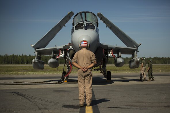 U.S. Marine Corps Lance Cpl. Jonathan L. Vega, from Miami, Florida, stands in front of an EA-6B Prowler while other Marines inspect the aircraft during Exercise Northern Edge 2015 June 15 at Eielson Air Force Base, Alaska. The Prowler is an electronic warfare aircraft used to jam radar signals making other military aircraft invisible to radar. NE15 is Alaska’s premier joint training exercise designed to practice operations, techniques and procedures as well as enhance interoperability among the services. Thousands of participants from all of the services, airmen, soldiers, sailors Marines and Coast Guardsmen from active duty, reserve and National Guard Units are involved. Vega is an aircraft mechanic with Marine Tactical Electronic Warfare Squadron 2, Marine Aircraft Group 14, 2nd Marine Aircraft Wing, II Marine Expeditionary Force. (U.S. Marine Corps Photo by Cpl. Thor J. Larson/Released)
