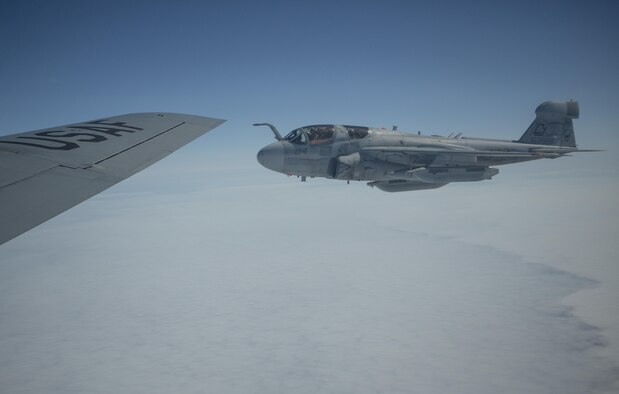 A U.S. Marine Corps EA-6B Prowler aircraft, assigned to the Marine Tactical Electronic Warfare Squadron 2, 2nd Marine Aircraft Wing, flies next to a U.S. Air Force KC-135R Stratotanker aircraft, assigned to the 459th Air Refueling Wing, Andrews Air Force Base, Md., Air Force Reserve, over the Gulf of Alaska, June 22, 2015. The aircraft was being refueled while flying a training mission during Exercise Northern Edge 15. Northern Edge is Alaska’s premier joint training exercise designed to practice operations, techniques and procedures as well as enhance interoperability among the services. Thousands of Airmen, Soldiers, Sailors, Marines and Coast Guardsmen from active duty, reserve and National Guard units are involved. (U.S. Marine Corps photo by Staff Sgt. Jeffrey D. Anderson/Released)
