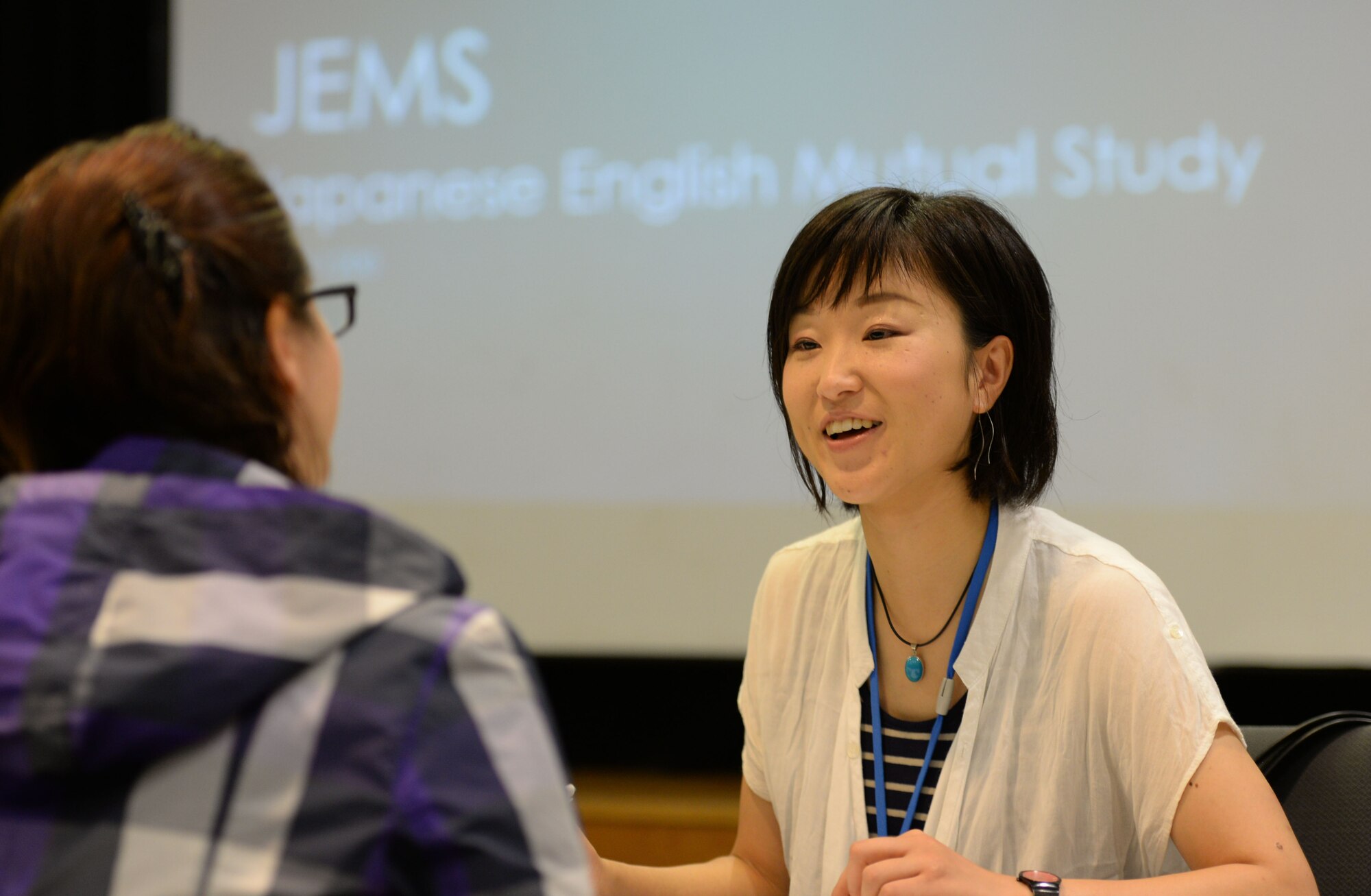 Japan Air Self-Defense Force Capt. Tae Hattori, Southwestern Composite Air Division Headquarters liaison officer, speaks with U.S. Air Force Capt. Vanessa Gomez, 353rd Special Operations Group comptroller, to during a Japanese English Mutual Study event on Kadena Air Base, Japan, June 20, 2015. During the event participants introduced their partner and spoke about their favorite things. (U.S. Air Force photo by Senior Airman Omari Bernard/Released) 