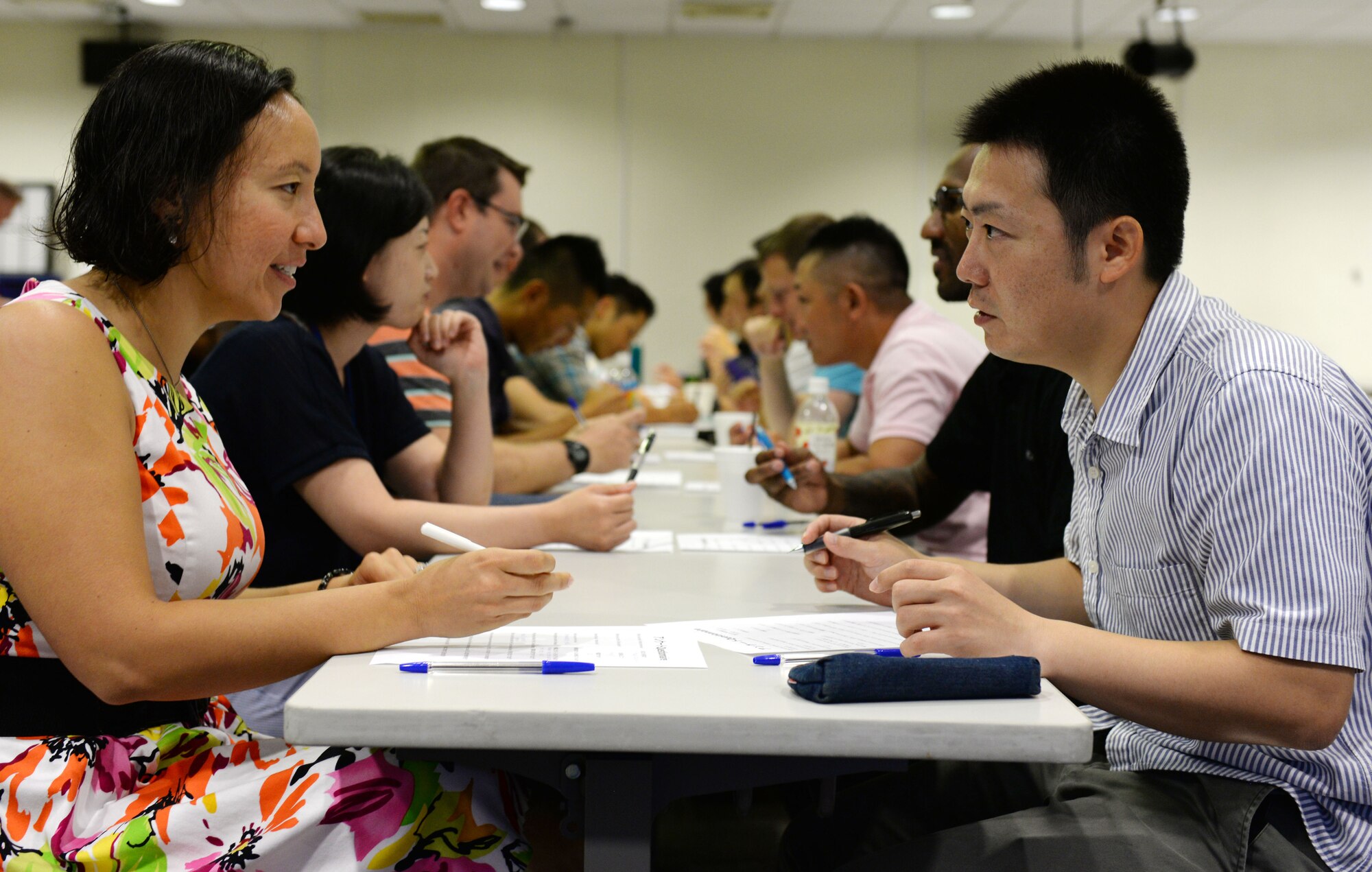 U.S. Air Force 1st Lt. Nicole Reale (left), 961st Airborne Air Control Squadron airfield battle manager, and Japan Air Self-Defense Force Capt. Takao, Southwestern Composite Air Division Headquarters communications officer, ask each other questions about their personal lives on Kadena Air Base, Japan, June 20, 2015. The purpose of JEMS is to foster stronger ties between the U.S. and Japanese militaries. (U.S. Air Force photo by Senior Airman Omari Bernard/Released)