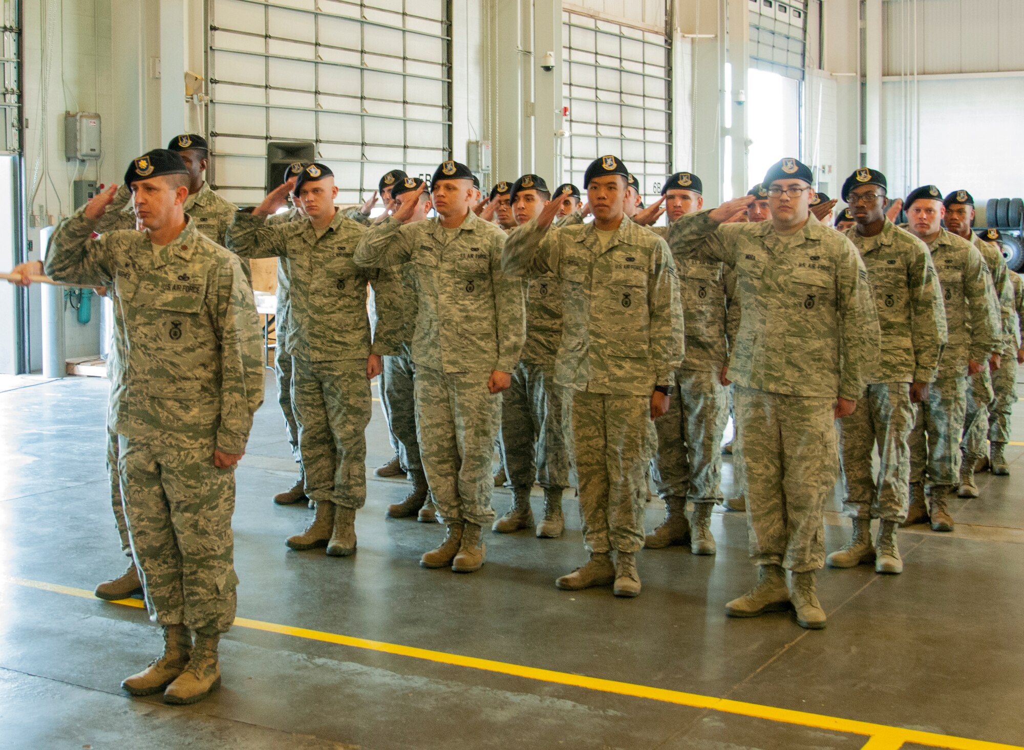 Defenders in the 90th Security Forces Group render a salute to Col. Christopher Corley, their new commander, at the 90th SFG Change of Command in the Peacekeeper High Bay on F.E. Warren Air Force Base, Wyo., June 29, 2015. Corley assumed command of the group during the ceremony which represents a formal transition of authority from the outgoing commanding to the incoming commander. (U.S. Air Force photo by Senior Airman Jason Wiese)