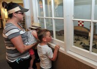 Danielle, Kassidy and Trevor Smith look at a diorama at the Malmstrom Air Force Base, Mont., museum June 29, 2015, representing lend-lease operations in Great Falls, Mont., during World War II. Approximately 8,000 American military aircraft were flown to Alaska and delivered to Russian pilots to use for combat against Germany. (U.S. Air Force photo/John Turner)